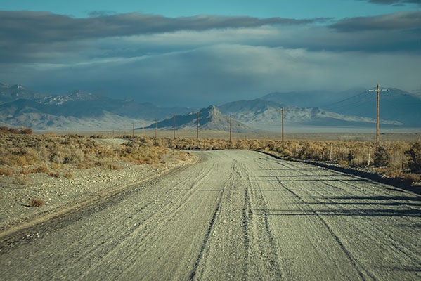 dirt road with mountain in the background