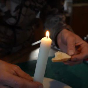 deer fat candle and a piece of bread with melted deer fat on it
