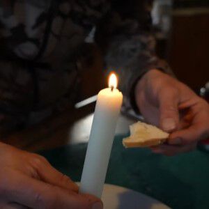 deer fat candle and a piece of bread with melted deer fat on it