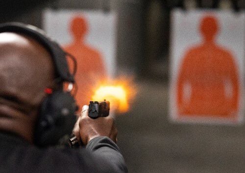 Man shooting targets at in indoor range