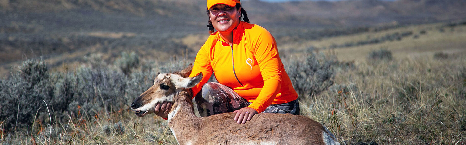 Woman in field with rifle