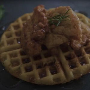 fried upland game sitting on top of a waffle