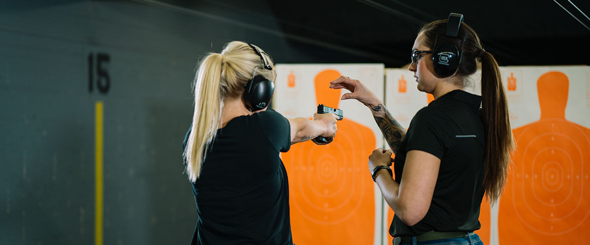 Two Women at an Indoor Gun Range