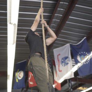 Dave Castro Climbing Up a Rope