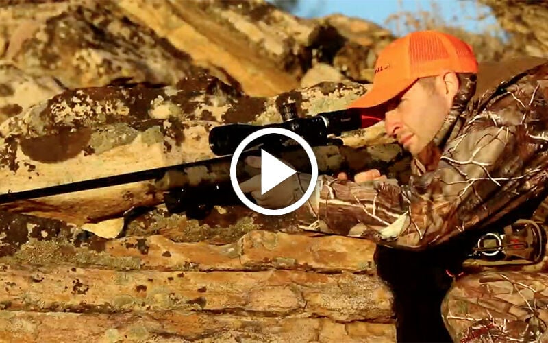 Man shooting lever action rifle