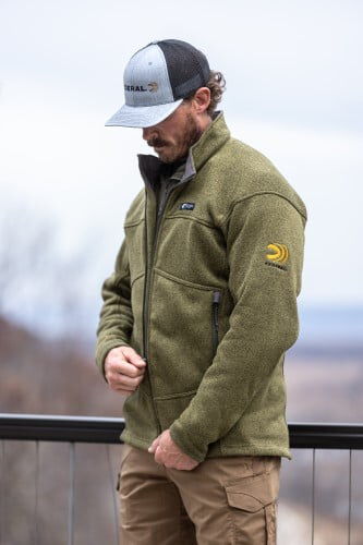 male wearing the Zenith Jacket and zipping up the front zipper