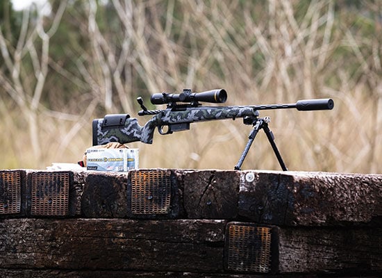 Terminal Ascent 6.5 Creedmoor +Peak box next to a suppressor rifle