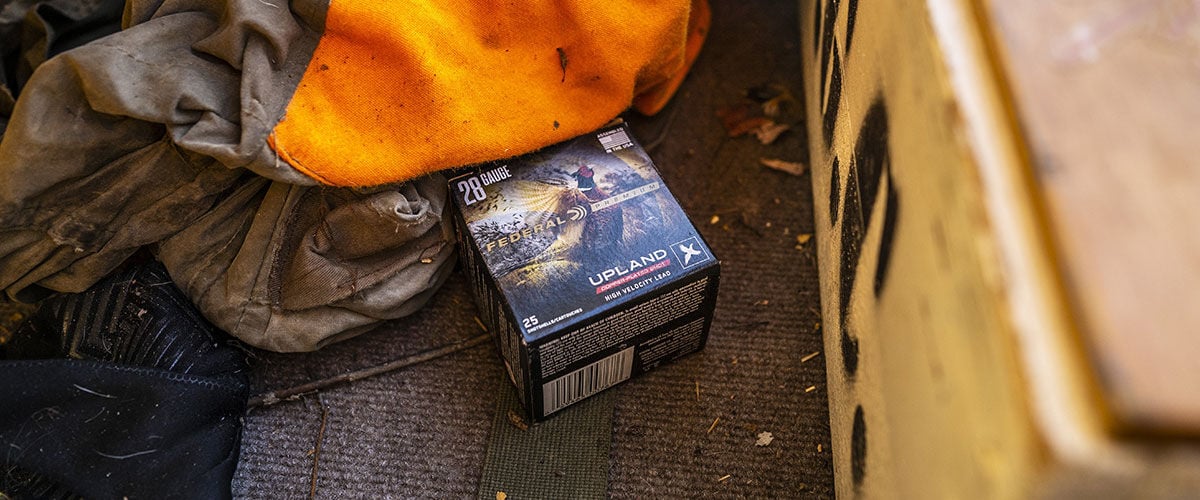 Upland box next to some hunting gear