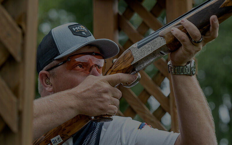 Shooter Derrik Mein aiming a shotgun