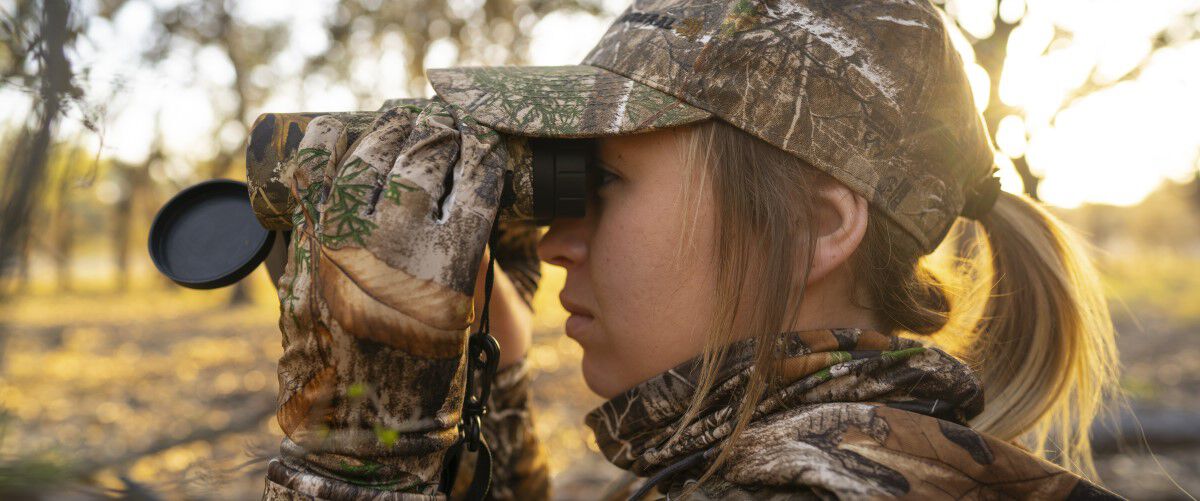 Hunter looking through binoculars