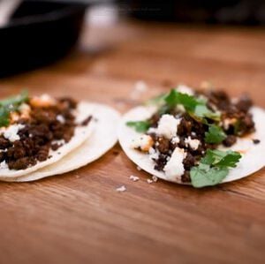 Two Wild Duck Chorizo Street Tacos sitting on a table