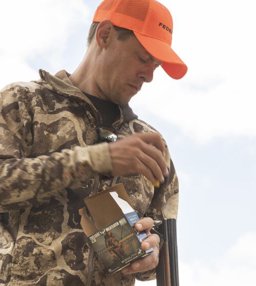 Steven Rinella loading Bismuth into his shotgun