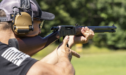 Man looking down the sights of a lever action rifle
