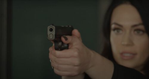 Krystal Dunn pointing a pistol