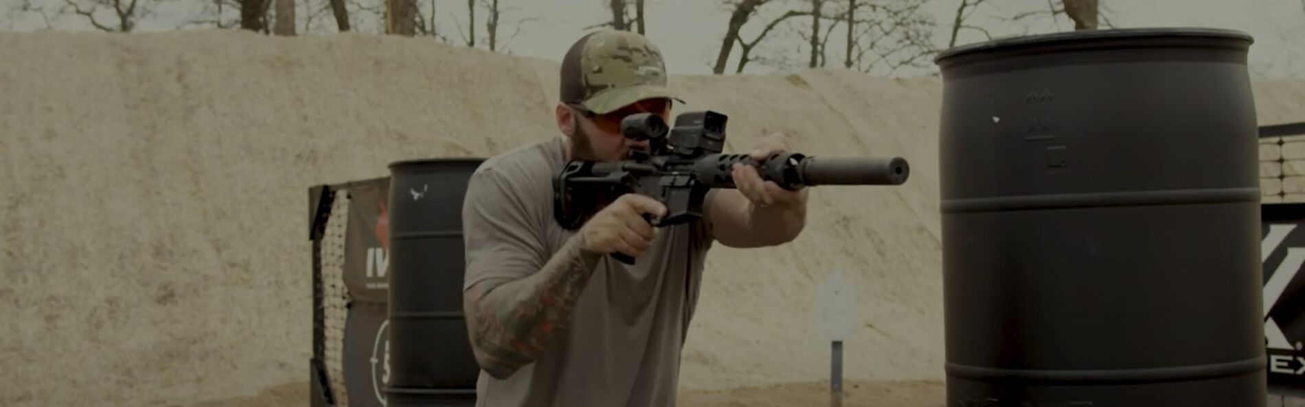 Josh Froelich holding a rifle at an outdoor range