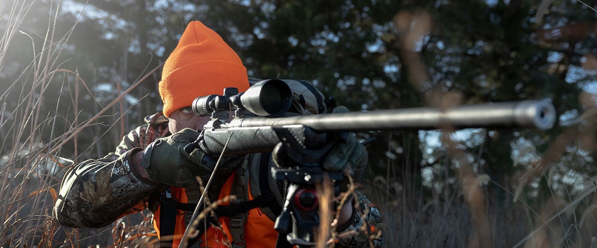 hunter aiming a rifle