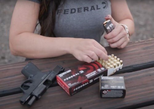 Krystal Dunn loading a magazine with American Eagle 30 Super Carry