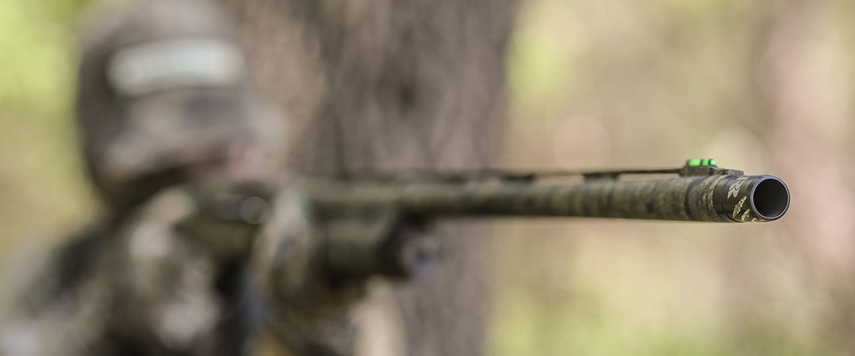 hunter aiming shotgun