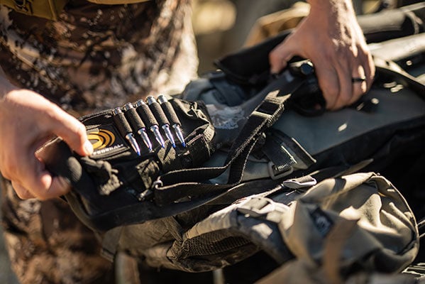 hunter adding cartridge holder to rifle loaded with 7mm Backcountry Terminal Ascent