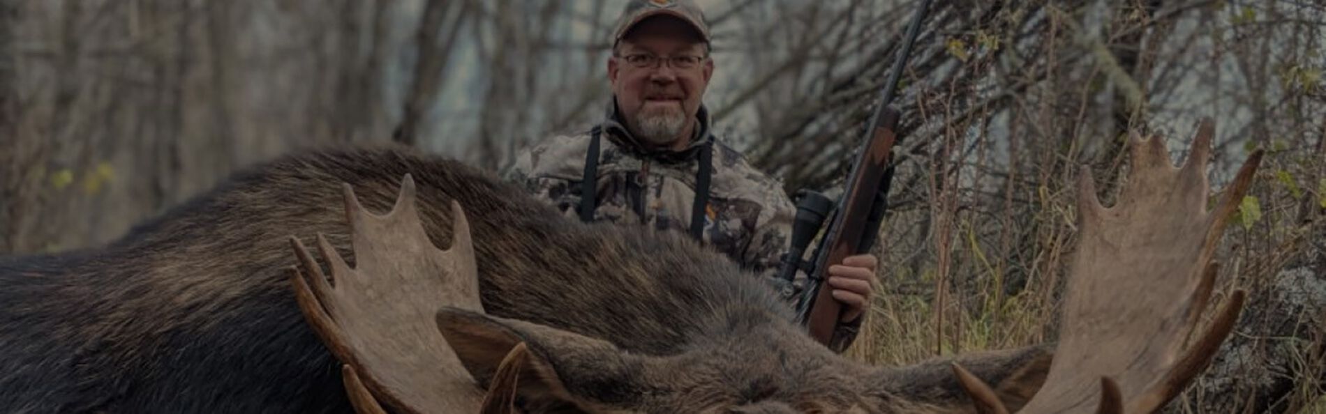 Hunter in front of a downed moose