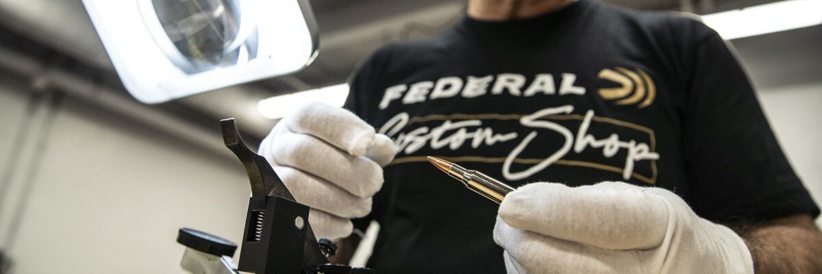 Custom Shop specialist inspecting Custom Rifle ammo