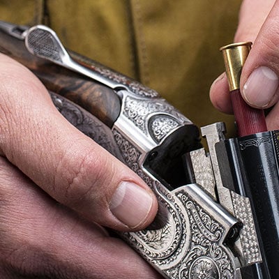 Custom Shop Shotshell being loaded into a shotgun