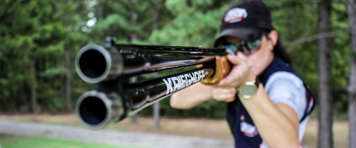 Kayle Browning shooting a shotgun