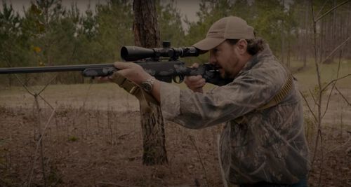 Jim Gilliland looking down the scrope of his rifle