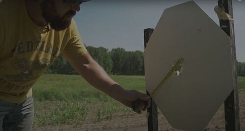 Josh Froelich measuring the pattern on a target