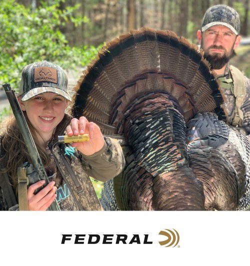 2 hunters showing off a tom and Federal ammunition