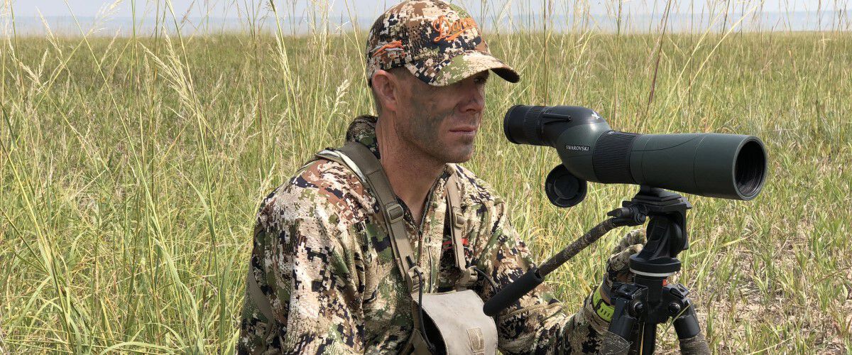 hunter looking through a spotting scope