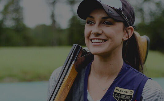 Kayle resting a shotgun on her shoulder