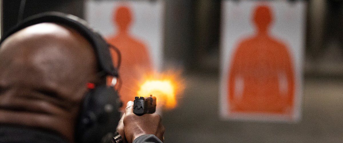 Man shooting targets at in indoor range