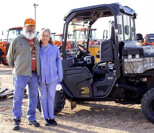 Chon Martinez of Anderson, Texas, and his wife, Mary, stand in front of a Federal-branded Kubota Sidekick utility vehicle he won through the 2020 Federal Kubota Sweepstakes.