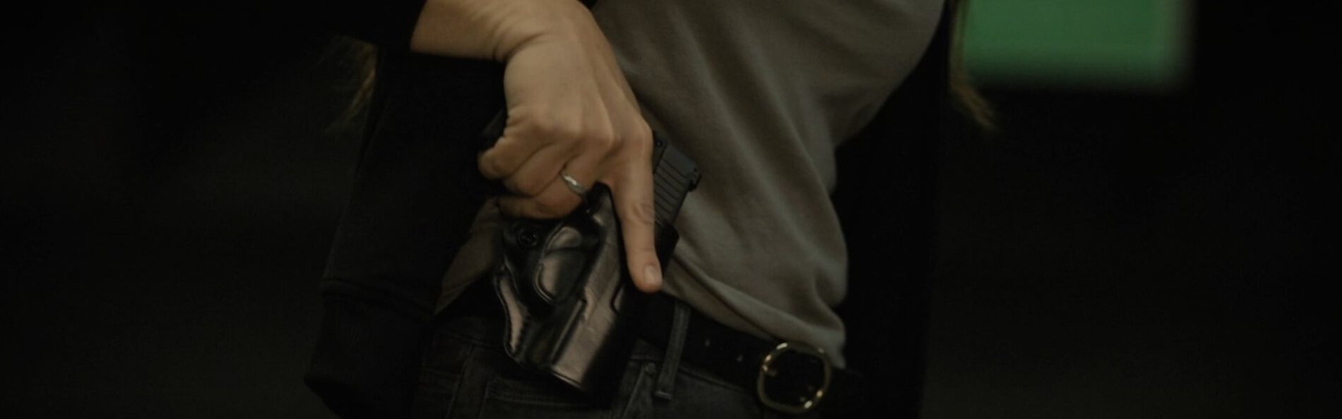 Krystal Dunn removing a handgun from its holster