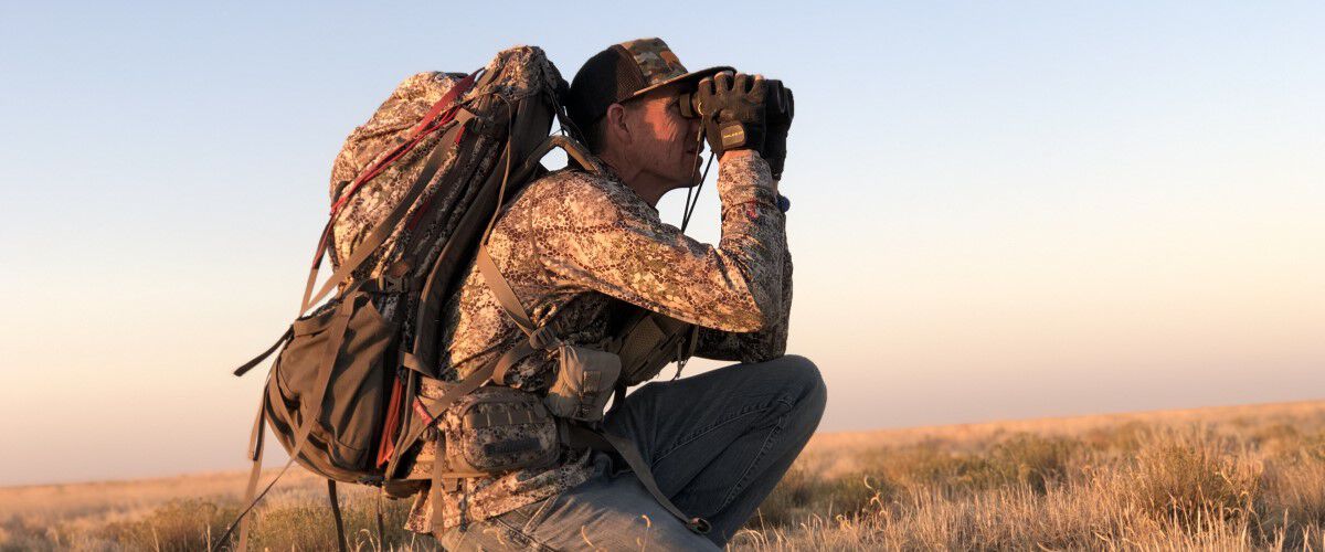 Hunter looking in binoculars