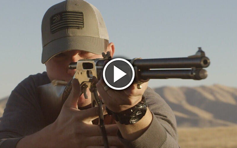 Man shooting lever action rifle