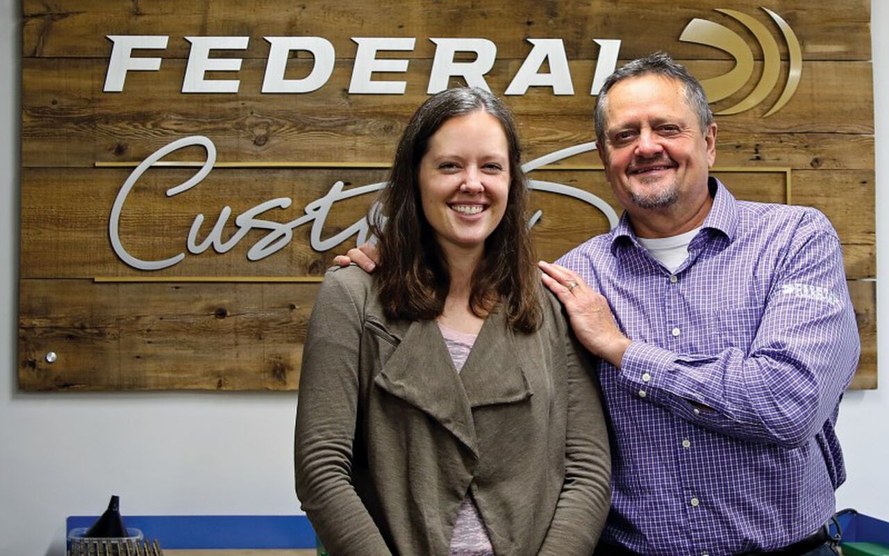 Brittany and her father in front of the Custom Shop sign