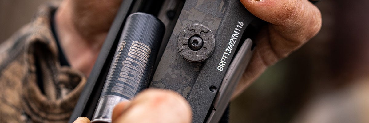 hunter loading Black Cloud into a shotgun