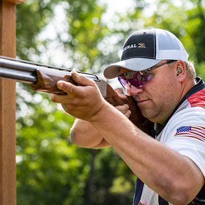 Derrik Mein aiming a shotgun