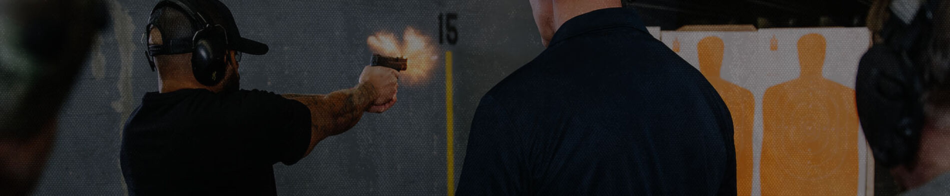 guy shooting a handgun at an indoor range