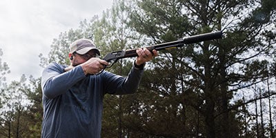 Jim Gilliland aiming lever action rifle