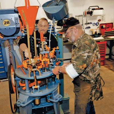 workers at a loading press in the factory