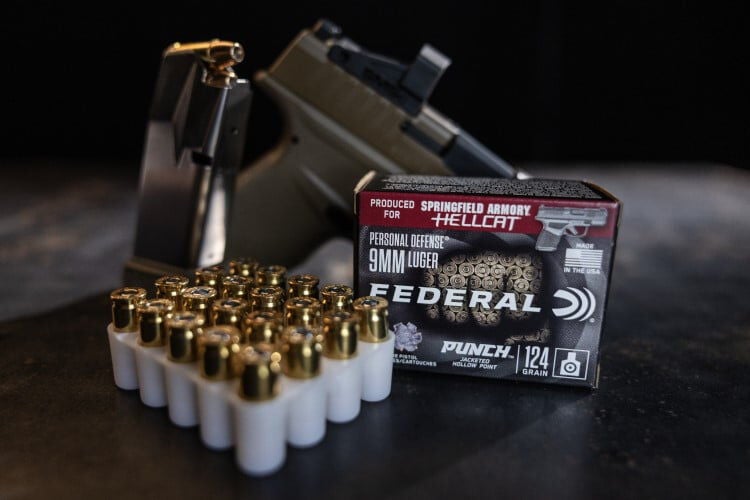 Punch Hellcat packaging and cartridges in front of a Springfield Armory Hellcat