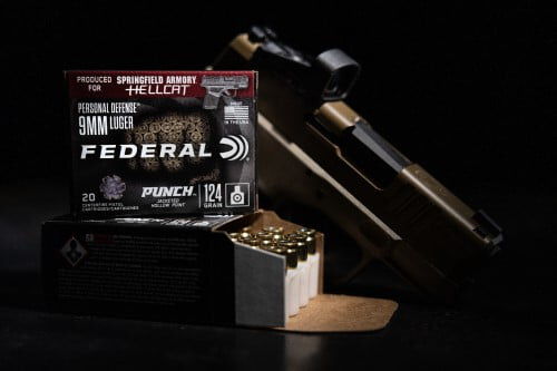 Punch Hellcat packaging and cartridges in front of a Springfield Armory Hellcat