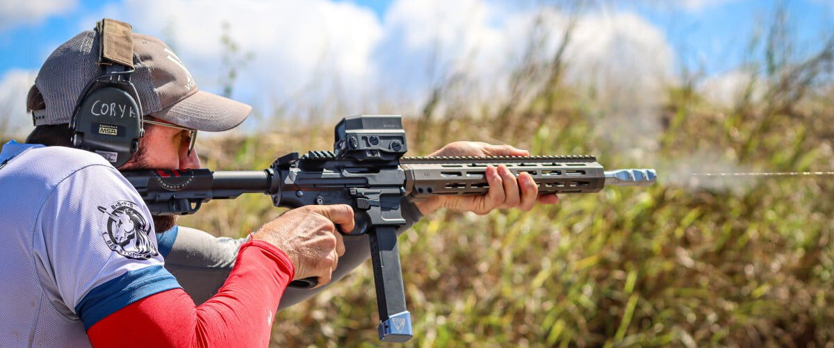 Cory Klemashevich looking down the sights of a rifle