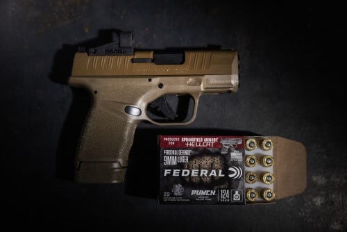 Punch Hellcat packaging and cartridges in front of a Springfield Armory Hellcat