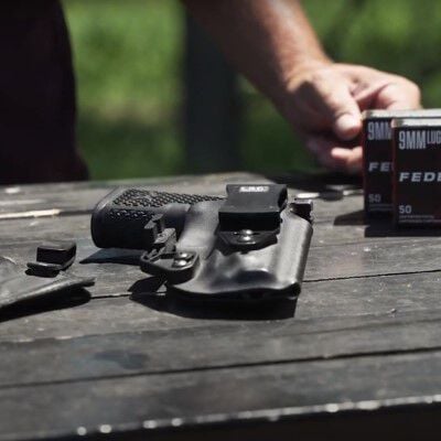 pistol laying on a table along with Federal American Eagle boxes