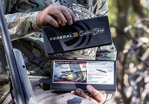 hunter loading Custom Shop ammunition into magazine