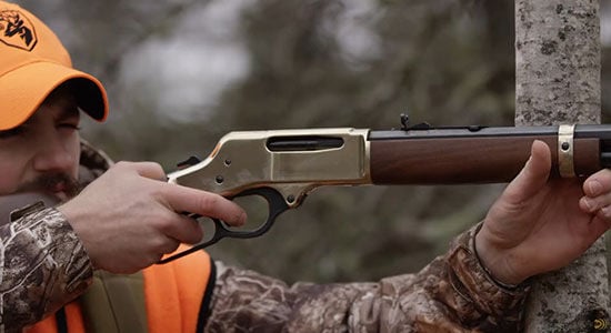hunter aiming lever action rifle